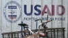 Signage for the US government's humanitarian agency USAID is seen on a cargo container beside a tricycle in Manila on February 4, 2025.