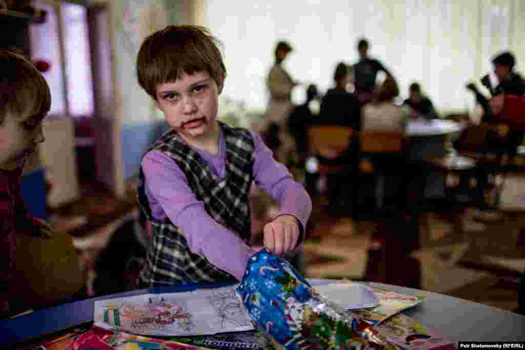 Boy in orphanage in Donetsk eating chocolate