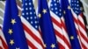 BELGIUM – This photo taken on May 15, 2017 in Brussels shows US and European Union flags at the EU headquarters. - US president Donald Trump will visit Brussels on May 25