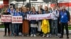 BELARUS -- Journalists of Belarusian TUT.BY media outlet hold banners reading "I don't protest but work", "This is me at work", "Freedom for journalists!", from left to right, as they stand in front of police station in Minsk, September 2, 2020